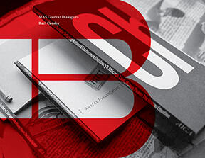 Black and white photograph of a stack of closed books with bold red letters partially overlaying the image.